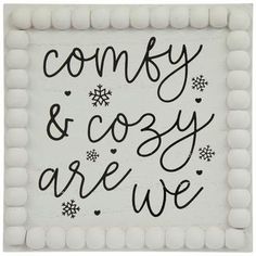 a sign that says, comfy and cozy are we? with snowflakes on it