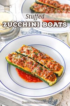 stuffed zucchini boats on a white plate with sauce and seasoning in the background