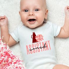 Grab this fun cheer baby bodysuit to announce your pregnancy, give at that next baby shower, or to just wear everyday! Made specifically with the coach's kid in mind, these bodysuits will remind the coach how much they are loved.  ⚜️Care Instructions:          - Turn bodysuit inside out and wash on cold          - Tumble dry on low temperature          - Do not iron directly on the lettering FOLLOW US Pinterest: @thegamedayfamily Instagram: @thegamedayfamily >>Thanks for your support of our shop Cheer Coach Shirts, Gift For Coach, Cheer Coach, Cheer Coaches, Cheer Gifts, Cheer Mom, Mom Mug, Toddler Tees, Gender Neutral Baby