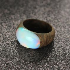 The design of this white opal ring is simple, elegant and comfortable for all day wear.Made from beautiful burl wood and white lab-created opal. The wood is polished by hand, giving it a nice sheen and making it silky smooth to the touch. The opal has a soft iridescent glow. This opal wood ring makes for a great gift for anyone with metal allergies.Please note that due to the nature of the materials used, with their various grains and patterns no two pieces will be exactly the same. Every piece Modern Round Opal Ring, Modern White Opal Ring For Gift, Modern White Round Opal Ring, 21st Birthday Ideas, Opal Birthstone Ring, October Birthstone Ring, Push Present, Unique Opal, Opal Birthstone