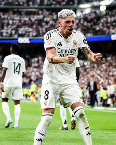 the soccer player is celebrating his goal in front of an audience at a sporting event