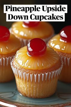 three cupcakes sitting on top of a plate covered in frosting and cherries