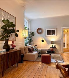 the living room is clean and ready for us to use it's natural wood flooring