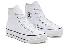 Make a statement with the Converse Chuck Taylor All-Star Hi Platform. Perfect for any occasion, this sneaker will keep you stylish and comfortable in pure white canvas construction. The lace-up closure is secured by matching metallic eyelets and features two inner midfoot eyelets for extra supportive. Along with the rubber toe cap to protect your feet and cushioned insoles, it’s equipped with a sturdy rubber sole provides excellent traction. An iconic look finished off with two black rubber stri All Star Platform, Casual Shoes Women Sneakers, Platform Chucks, Casual Athletic Shoes, Chuck Taylor All Star Lift, Platform Converse, New Converse, Converse White, White Converse