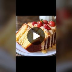 a piece of cake sitting on top of a white plate covered in frosting and strawberries