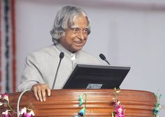 a man standing at a podium with a microphone