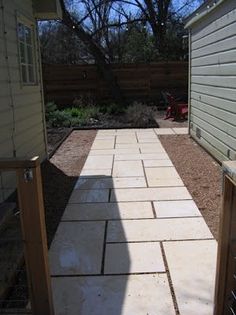 an open door leading to a back yard with a brick walkway and fenced in area