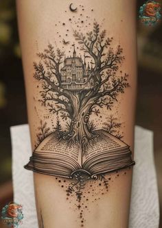 an open book with a tree on it and a house in the pages tattoo design