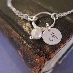 Pearl bridesmaid bracelet with initial Personalized silver | Etsy Silver Pearl Bracelet With Pearl Charm For Mother's Day, Elegant Hand Stamped Necklaces For Wedding, Sterling Silver Pearl Bracelet Gift, Pearl Bracelet With Pearl Charm For Bridesmaids, Wedding Sterling Silver Round Pearl Bracelet, Silver Bracelets With Pearl Charm As Gift, Silver Monogram Jewelry For Wedding, Delicate Silver Initials Jewelry, Sterling Silver Bracelet For Bridesmaids