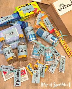 the contents of a personal care kit laid out on top of a wooden table next to a package of toothpaste