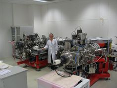 a man standing next to some machines in a room