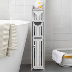 a white shelf next to a bath tub in a bathroom