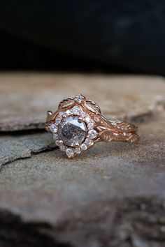 a diamond ring sitting on top of a rock