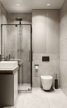 a bathroom with a toilet, sink and shower stall in the middle of it's walls