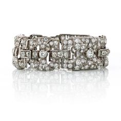 Beautiful 1930's Art Deco bracelet crafted in Platinum set with old European cut diamonds of 22 carats total weight. This bracelet is light and elegant. Truly a beautiful showcase of the Art Deco era.Details: Art Deco Open Work 22 carats DiamondTotal Carat Weight: 22.00Measurements: 7 InchesMetal Type: PlatinumMetal Weight: 55.4 gr.Condition: Vintage. Good.Stock: RR5982 Emerald Cut Diamond Ring, Art Deco Bracelet, Platinum Metal, European Cut Diamonds, Deco Jewelry, Art Deco Era, Antique Diamond, Women Diamond, Bracelet Crafts