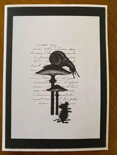 a card with an ink drawing of a snail on top of mushrooms and other things