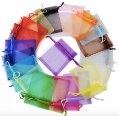 many colors of organine bags are arranged in the shape of a circle on a white background