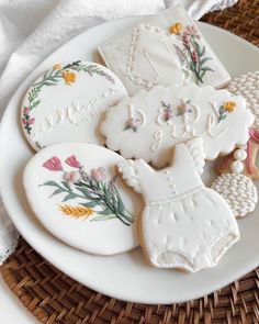 some decorated cookies are on a white plate