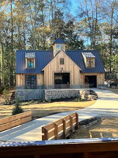 a wooden house with a metal roof in the woods