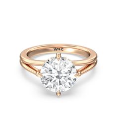 a rose gold engagement ring with a round cut diamond in the center, on a white background