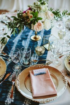 the table is set with place settings for dinner