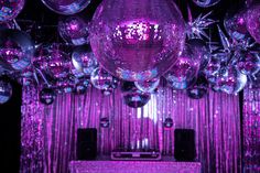 purple disco balls are hanging from the ceiling