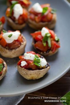 small stuffed mushrooms topped with tomatoes and cheese