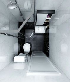 a bathroom with a toilet, sink and shower stall in black and white color scheme