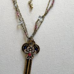 a necklace with an antique key on it