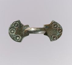 Equal-armed brooch.  Frankish, 7th century CE.  Medium:  copper alloy.  Dimensions: Overall: 1 7/16 x 9/16 x 1/2 in. (3.6 x 1.4 x 1.2 cm). Classification: Metalwork-Copper alloy. Credit Line: Gift of J. Pierpont Morgan, 1917. Accession Number: 17.191.292.  In the Metropolitan Museum of Art, New York. Medieval Horse, Period Pieces, France Culture, Northern France, Early Medieval, A3 Poster, Byzantine Art, Medieval Jewelry