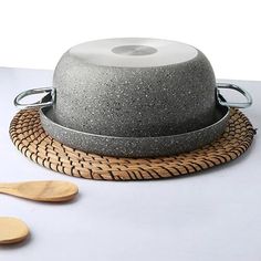 a bowl and wooden spoons sitting on a table