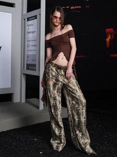 Striking pants in a muted earth-tone abstract print. Features a high waist and dramatically flowing silhouette. Unique pattern resembles organic textures or camouflage. Luxurious fabric drapes elegantly to the floor. Perfect for making a bold statement in haute couture or avant-garde fashion contexts. Model: 173cm/48kg Wearing size M North Node, Arcana Archive, Flower Retro, Avant Garde Fashion, Pants Suit, Printed Trousers, Draped Fabric, British Indian, Pitcairn Islands