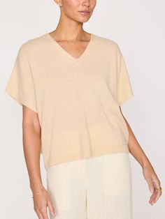 Runs true to size T-shirt silhouette Relaxed fit Vee neckline with notch split detail Light ribbing on the neckline, sleeves and hem Straight hem Signature center back seam detail 100% Cashmere Imported We love our Ophi Vee…the perfect 100% cashmere t-shirt to be layered now and worn on its own later. In a relaxed fit with short sleeves, it feels modern, while the subtly of the design feels sensual and feminine. No bells and whistles needed…our Ophi cashmere sweater is simplicity at its finest. Luxury Cashmere Tops With Relaxed Fit, Luxury Relaxed Fit Cashmere Tops, Chic Cashmere Textured Knit Top, Beige Relaxed Fit Cashmere Sweater, Fine Knit Cashmere V-neck Tops, Shirt Silhouette, Fits With Shorts, Dog Sweaters, Animal Welfare