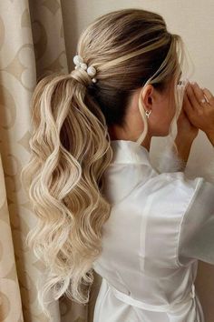 a woman with long blonde hair in a ponytail