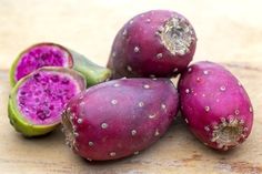 some purple fruit sitting on top of a wooden table