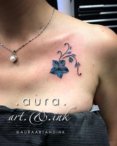 a woman with a blue flower tattoo on her chest