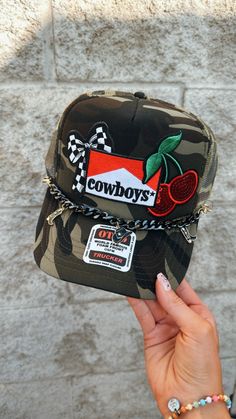 camo women's trucker hat that says Cowboys. sequin cherries, skull cowboy, and gold and black chain with cowboy boots and hat. makes for the perfect gift! Western Trucker Hats, Aesthetic Checkered, Country Hair, Hat With Patches, Camo Trucker Hat, Dope Hats, Women Trucker, Turquoise Western, Custom Trucker Hats