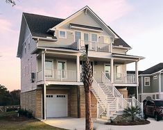 two story house with white balconies and stairs