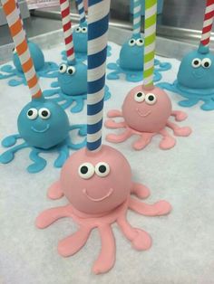 octopus cake pops with candy sticks in the shape of eyes and legs on display at a store