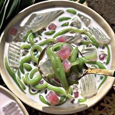 a bowl filled with green beans and sauce