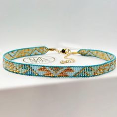 Meticulously woven on a durable leather cord with a robust thread base, this beaded choker in a beautiful gradient of colors, ranging from light turquoise to emerald green, elegantly framed with golden beaded.   ------------------Choker Size ---------------                                                                                                                                                                                                     Length: 12 inch (30,5 cm) + extension chain 1,6 inch  (4 cm)                12,5 inch (31,7 cm) + extension chain 1,6 inch  (4 cm)                 13 inch (33 cm) + extension chain 1,6 inch  (4 cm) Wide - 0.39 inch (1cm)     ------------------ Material---------------------- Turquoise leather cord. Beaded : Turquoise, Light Green, Emerald & Gold Light Green Emerald, Beautiful Gradient, Jewelry Gift Ideas, Gift Ideas For Her, Turquoise Leather, Adjustable Jewelry, Light Turquoise, Green Emerald, Beaded Choker