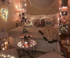 a bedroom decorated with lights and pillows