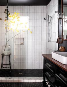 a bathroom with black and white tiled walls