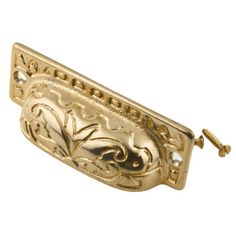 an ornate gold door handle on a white background