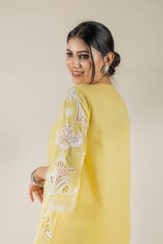 PRODUCT DETAIL: This bright and vibrant set comes laden with a beautiful cutwork embroidery. The lace detailing on the shirt and the tulip pants adds to the beauty of the outfit. *The length of the shirt can be customised. Contact us to get yours as per your preferences. SPECIFICATIONS: Color Yellow Fabric Cotton Product Code RANG18 Traditional Palazzo Set With Embroidered Sleeves, White Designer Sets With Embroidered Sleeves, Designer White Sets With Embroidered Sleeves, Festive Cotton Sets With Embroidered Sleeves, Spring Wedding Straight Kurta Top, Designer Lace Work Kurta, Yellow Long Sleeve Palazzo Set With Chikankari Embroidery, Spring Traditional Palazzo Set With Embroidered Sleeves, Embroidered Long Sleeve Palazzo Set For Wedding