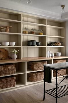 a room with many shelves and baskets in it