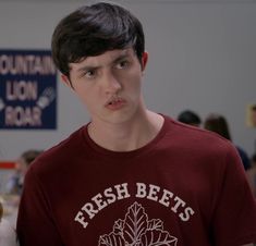 a young man in a t - shirt with the words fresh beets on it