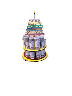 a birthday cake made out of cans on a yellow plate with candles in the middle