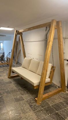 a wooden swing bed in an empty room