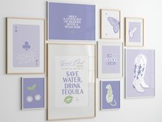 there are many framed pictures on the wall with purple and white designs around them,